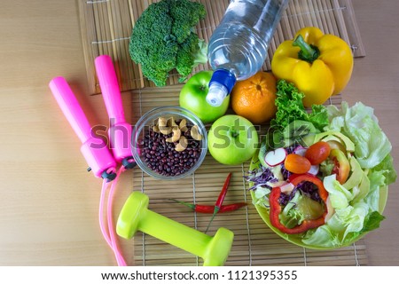 Healthy eating of ketogenic diet meal plan with Workout and fitness dieting ,fitness and weight loss concept, fruit, Vegetable and orange juice,salad,top view on wooden background, Food and health.