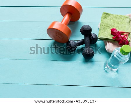Workout and fitness dieting- Healthy lifestyle concept and other stuff Dumbbell, water, on the blue wooden background