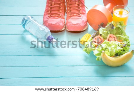Healthy eating with Workout and fitness dieting ,fitness and weight loss concept, fruit, Vegetable and orange juice,notebook,top view on blue wooden background,vintage tone