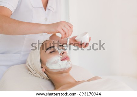 Spa facial mask application. Spa beauty organic facial mask application at day spa salon.