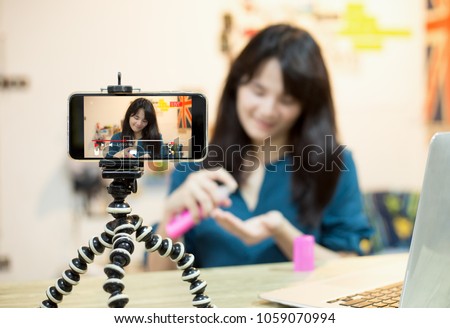 influencer marketing,Live video blogger concept.young vlogger girl live broadcasting  about cosmetic content via mobile phone