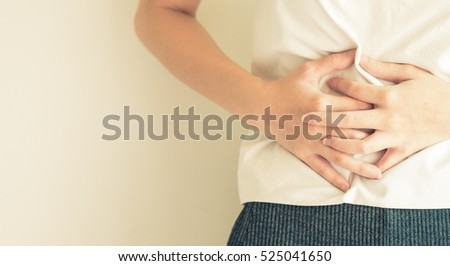 woman stomach ache because of gastritis or menstruation and digestive that are sign of stomach trouble