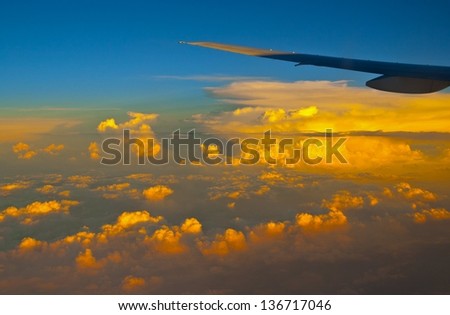 The clouds in the setting sunshine. The picture was taken in the plane.