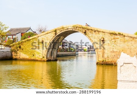 SUZHON, JIANGSU/CHINA-APR 11: Suzhou old town canals and stone bridge on Apr 11,2015 in Suzhou, Jiangsu, China. Suzhou is one of the old watertowns in China. It is a famous tourist destination.