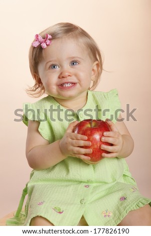 Gorgeous baby won\'t let go off her apple