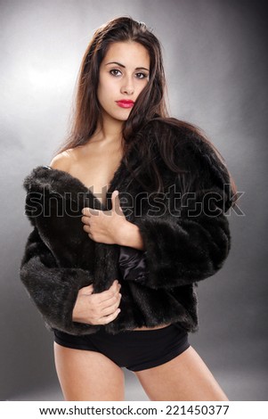 Cute brunette in fur jacket, shorts and not much else