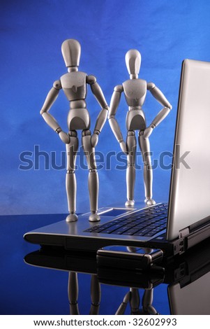 A couple of dummies claim victory after fixing a laptop.