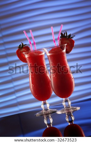 Strawberry daiquiri cocktail on wavy blue may be an innocent smoothie if there\'s no alcohol in it