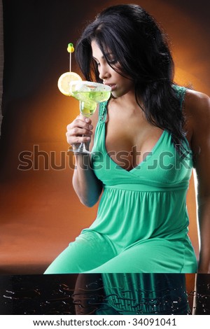 Young woman sips a Margarita. Shot to match the \