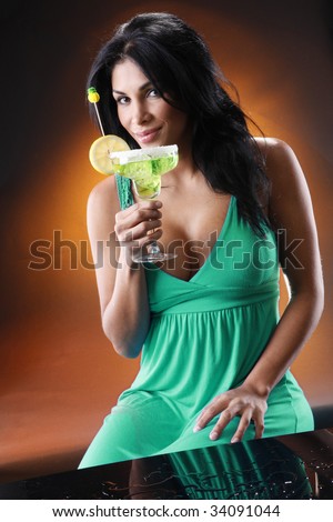 Young woman sips a Margarita. Shot to match the \
