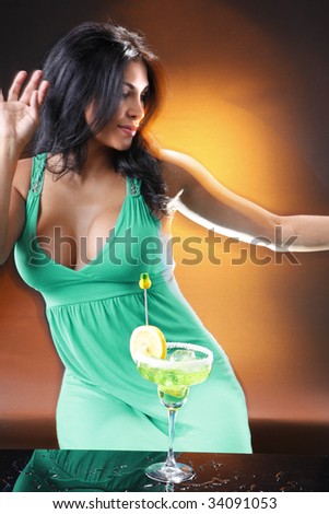 Young woman sips a Margarita. Shot to match the 