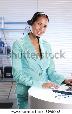 Customer support professional keeps records updated with a laptop