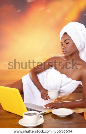 Cute girl gets her email while having her morning coffee