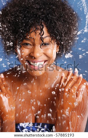 Cute African American splashes water to clean her face