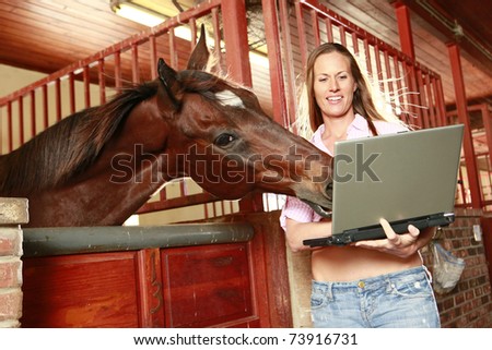 Blond and her horse check their social media site
