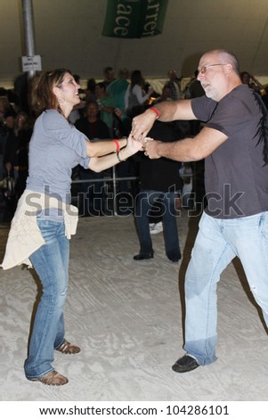 TULSA, OK - OCT 20: Party goers dance and drink beer at Oktoberfest in TULSA, OK, on October 20, 2011 in TULSA, OK. Tulsa is the origin of the first Oktoberfest Chicken Dance in the United States.