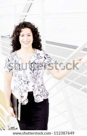 Pretty business woman walking on stairs