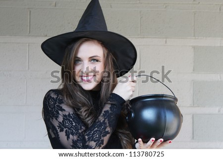 Pretty witch with a cauldron