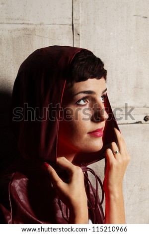 Woman in a black hood looking out