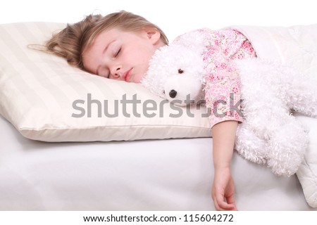A little girl sleeping on a large white pillow