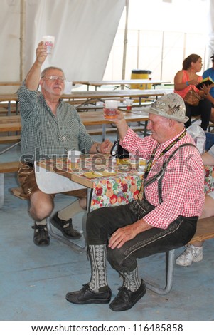 TULSA, OK - OCT 20: Party goers drink beer and sing songs at Oktoberfest in TULSA, OK, on October 20, 2012 in TULSA, OK.  Tulsa is the origin of the Chicken Dance now so popular at the Oktoberfest.