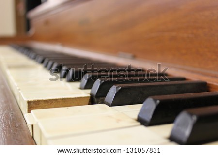 Piano keys of an old traditional piano instrument