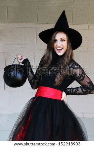Pretty witch in black hat