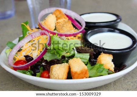 Salad with onions and ranch dressing