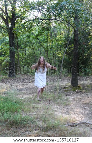 A woman in a dirty white dress, possibly a zombie, hides in a dark forest