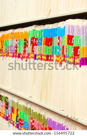 Rows of medical files with colorful tabs