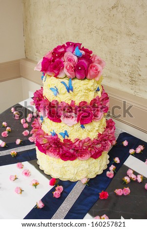White and red cake with roses and butterflies
