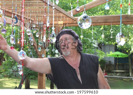 MUSKOGEE, OK - MAY 24: Merchant shows off his crafts for sale at the Oklahoma 19th annual Renaissance Festival on May 24, 2014 at the Castle of Muskogee in Muskogee, OK
