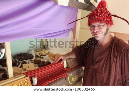MUSKOGEE, OK - MAY 24: A merchant shows off crafts at his sale stand at the Oklahoma 19th annual Renaissance Festival on May 24, 2014 at the Castle of Muskogee in Muskogee, OK.