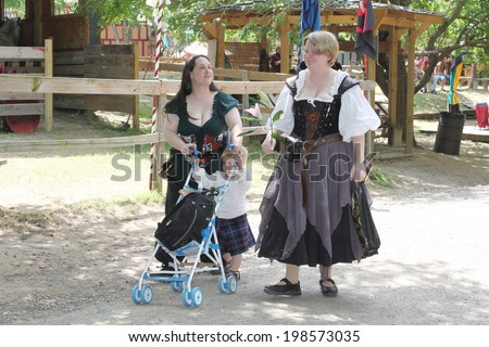MUSKOGEE, OK - MAY 24: Women dressed in historical costume stop for a picture at the Oklahoma 19th annual Renaissance Festival on May 24, 2014 at the Castle of Muskogee in Muskogee, OK.