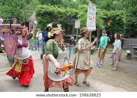 MUSKOGEE, OK - MAY 24: Actors dressed in historical outfits walk in the village parade during the Oklahoma 19th annual Renaissance Festival on May 24, 2014 at the Castle of Muskogee in Muskogee, OK.