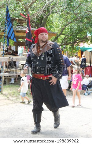 MUSKOGEE, OK - MAY 24: A man dressed as a pirate stops to talk during the Oklahoma 19th annual Renaissance Festival on May 24, 2014 at the Castle of Muskogee in Muskogee, OK.