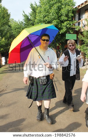 MUSKOGEE, OK - MAY 24: A man dressed in Scottish kilt walks around the village during the Oklahoma 19th annual Renaissance Festival on May 24, 2014 at the Castle of Muskogee in Muskogee, OK.