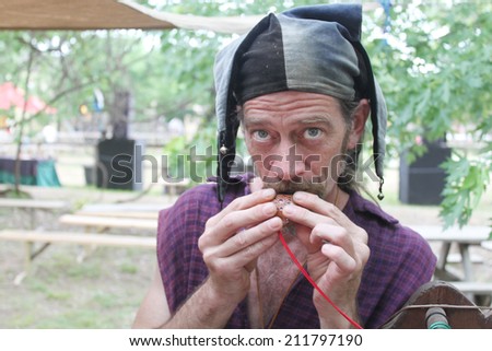 MUSKOGEE, OK - MAY 24: Whistle and flute maker shows off his newly crafted item at the Oklahoma 19th annual Renaissance Festival on May 24, 2014 at the Castle of Muskogee in Muskogee, OK