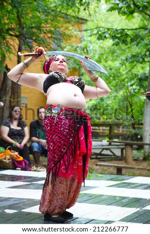 MUSKOGEE, OK - MAY 24: A woman dressed as Gypsy dances at the Oklahoma 19th annual Renaissance Festival on May 24, 2014 at the Castle of Muskogee in Muskogee, OK.
