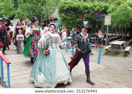 MUSKOGEE, OK - MAY 24: Actors dressed in historical outfits walk in the village parade during the Oklahoma 19th annual Renaissance Festival on May 24, 2014 at the Castle of Muskogee in Muskogee, OK.