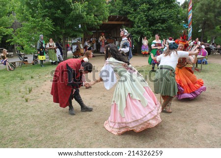 MUSKOGEE, OK - MAY 24: People dressed in historical costumes dance at the Oklahoma 19th annual Renaissance Festival on May 24, 2014 at the Castle of Muskogee in Muskogee, OK.