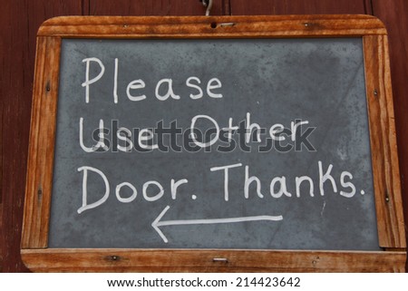 Please use other door Sign on a door in chalk pen.