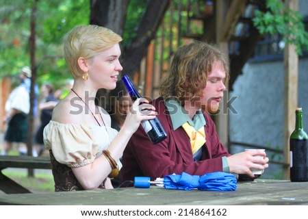 MUSKOGEE, OK - MAY 24: A couple of festival goers enjoy a drink during the Oklahoma 19th annual Renaissance Festival on May 24, 2014 at the Castle of Muskogee in Muskogee, OK