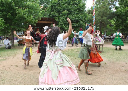 MUSKOGEE, OK - MAY 24: People dressed in historical costumes dance at the Oklahoma 19th annual Renaissance Festival on May 24, 2014 at the Castle of Muskogee in Muskogee, OK.