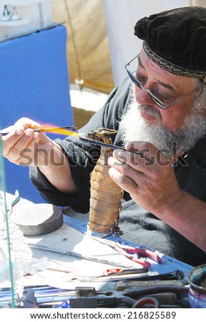 MUSKOGEE, OK - MAY 24: Skillful merchant shows off his crafts at the Oklahoma 19th annual Renaissance Festival on May 24, 2014 at the Castle of Muskogee in Muskogee, OK