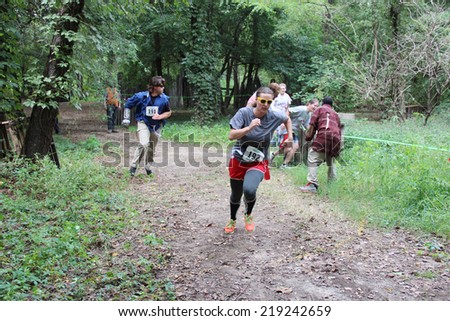 MUSKOGEE, OK - Sept. 13: Athletes try to avoid bloody zombies during the Castle Zombie Run at the Castle of Muskogee in Muskogee, OK on September 13, 2014.