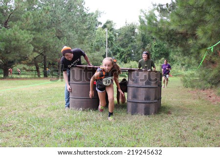 MUSKOGEE, OK - Sept. 13: Athletes try to run through obstacles and avoid bloody zombies during the Castle Zombie Run at the Castle of Muskogee in Muskogee, OK on September 13, 2014.