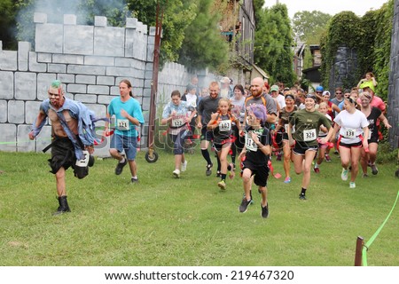 MUSKOGEE, OK - Sept. 13: Runners start at a difficult zombie-infested course during the Castle Zombie Run at the Castle of Muskogee in Muskogee, OK on September 13, 2014.