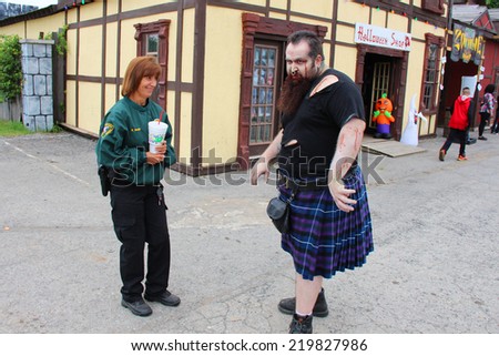 MUSKOGEE, OK - Sept. 13: A weird zombie in Scottish kilt terrorizing visitors at the village before the Castle Zombie Run at the Castle of Muskogee in Muskogee, OK on September 13, 2014.