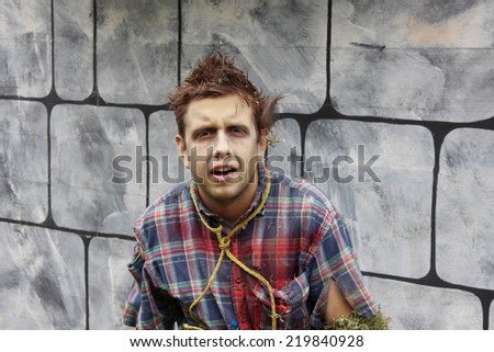 MUSKOGEE, OK - Sept. 13: Bloodied actor scares runners during the Castle Zombie Run at the Castle of Muskogee in Muskogee, OK on September 13, 2014.